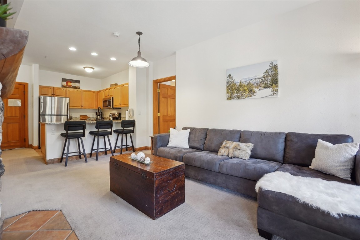 22714 Highway 6, Unit 5941 Keystone, CO 80435 - Photo 7 of 41 a living room with furniture kitchen view and a chandelier