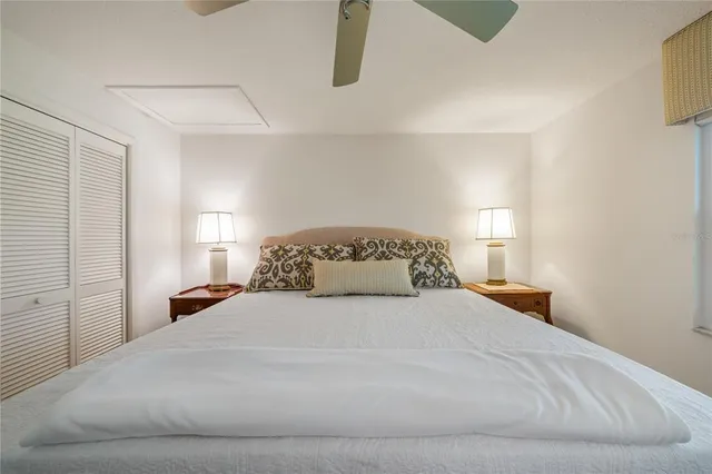 a spacious bedroom with a bed and ceiling fan