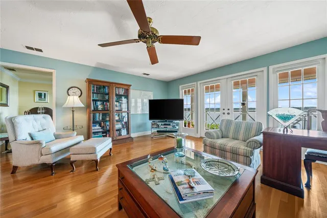 a kitchen with stainless steel appliances granite countertop a refrigerator a sink dishwasher a stove and white countertops with wooden floor