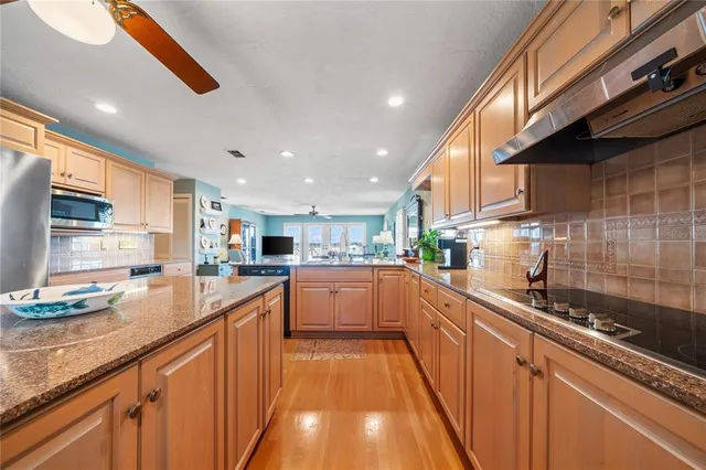 an aerial view of a house with outdoor space and lake view in back