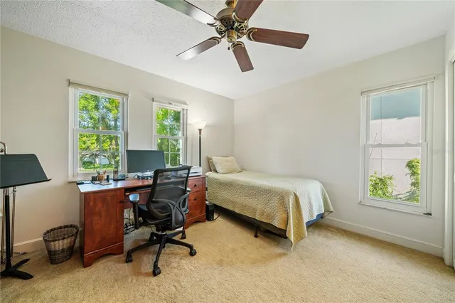 a aerial view of a house with a yard table and chairs