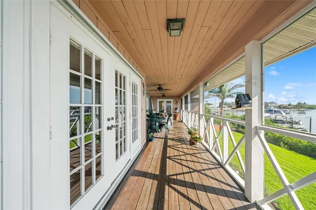 an aerial view of residential houses with outdoor space and ocean view