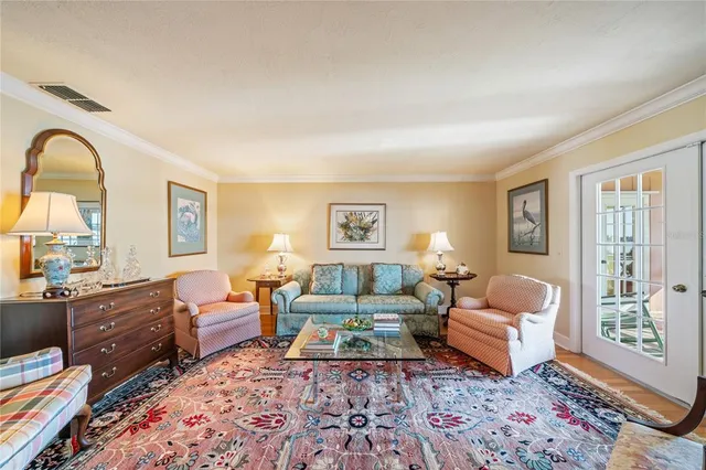 a view of a dining room with furniture a chandelier and wooden floor