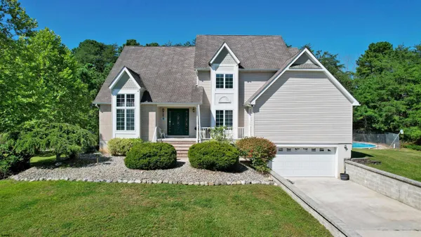 a view of a house with a yard and plants