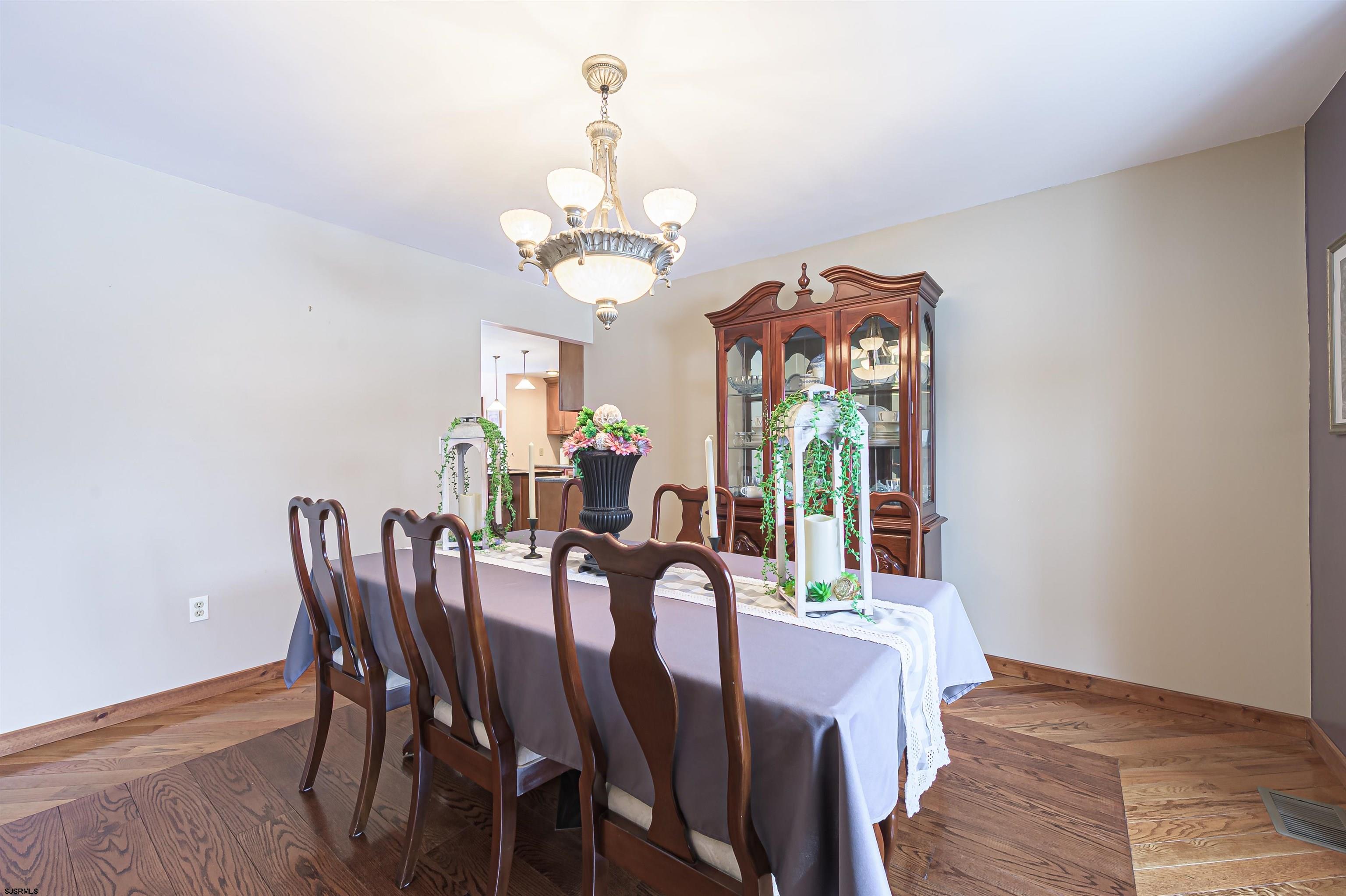 892 Hogbin Road Millville, NJ 08332 - Photo 11 of 63 a view of a dining room with furniture a chandelier and wooden floor