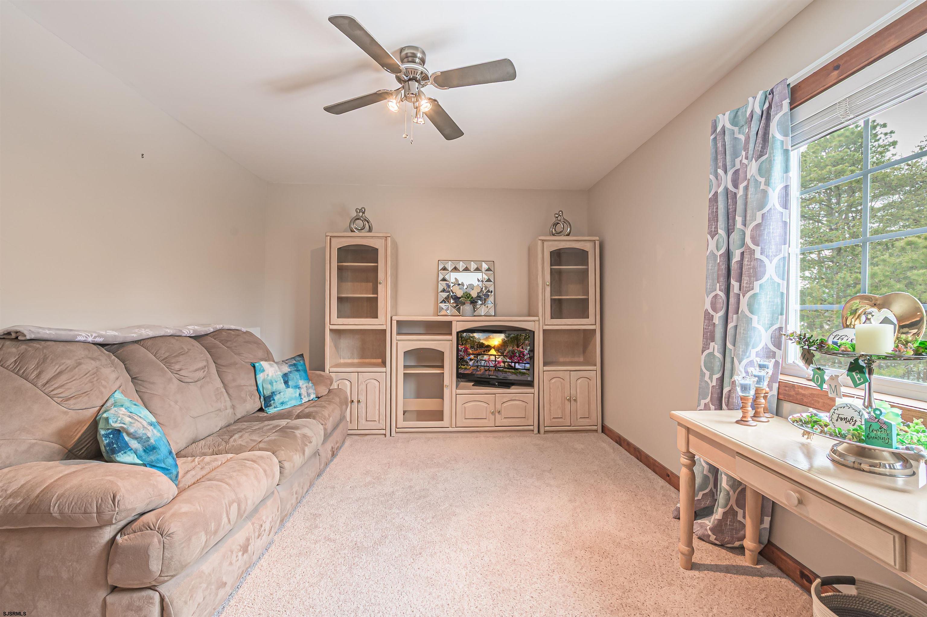 892 Hogbin Road Millville, NJ 08332 - Photo 35 of 63 a living room with furniture and a flat screen tv