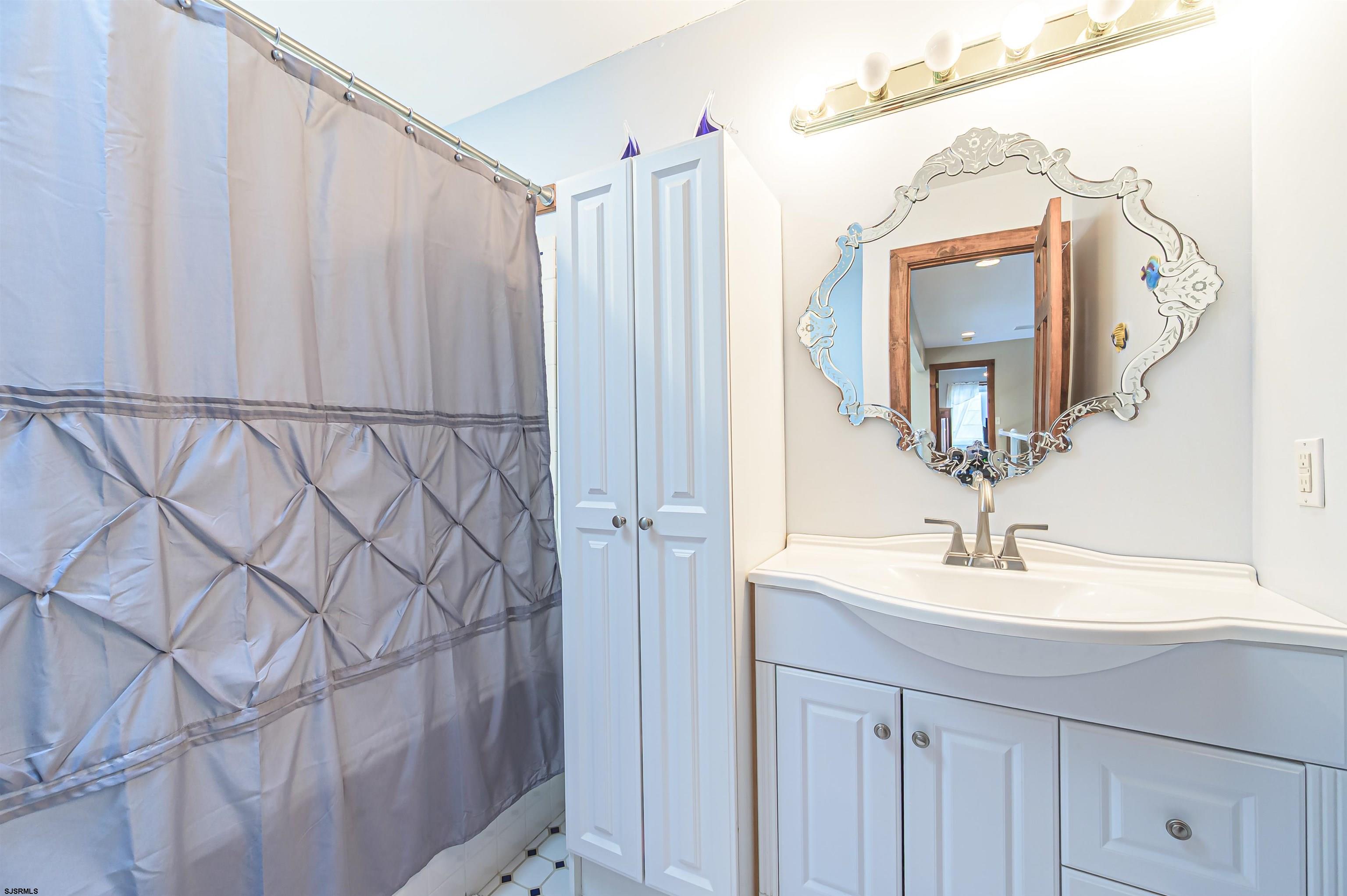892 Hogbin Road Millville, NJ 08332 - Photo 36 of 63 a bathroom with a sink and a mirror