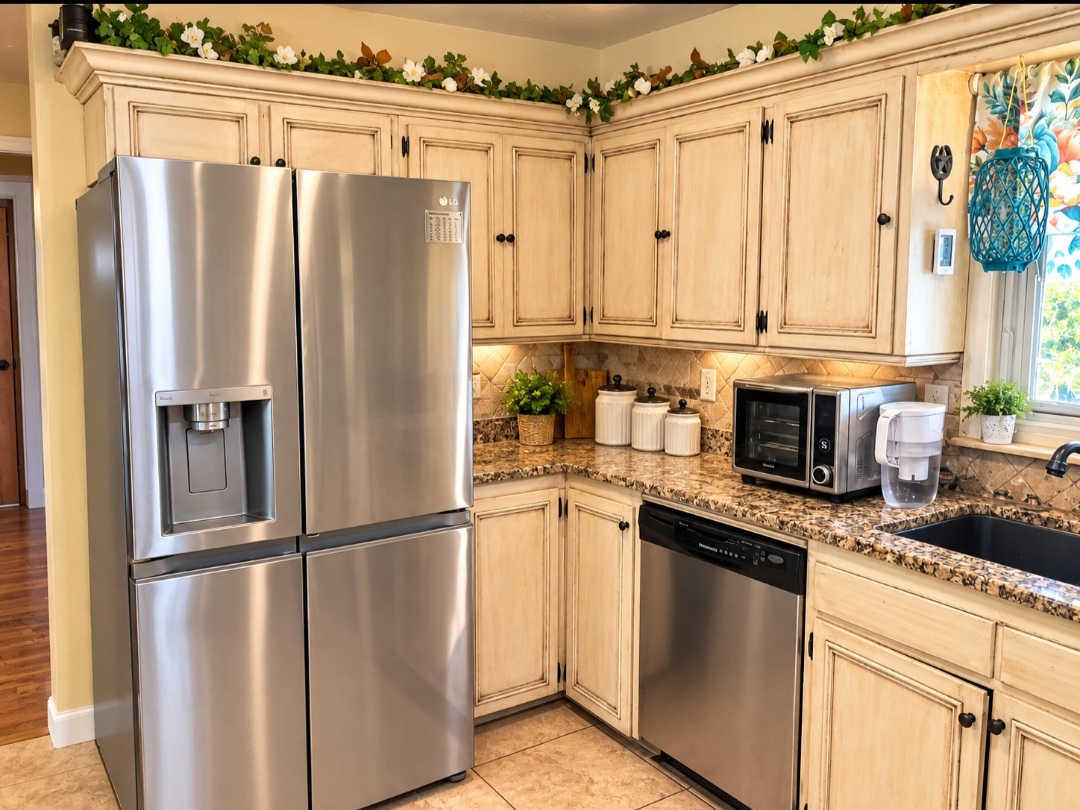 12526 3520th Road Seminole, OK 74868 - Photo 11 of 42 Distressed wood-finish cabinetry, stainless steel appliances, granite countertops, tile backsplash, and under-cabinet lighting