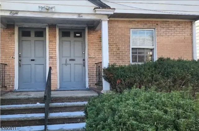 a front view of a house with a shower and garage