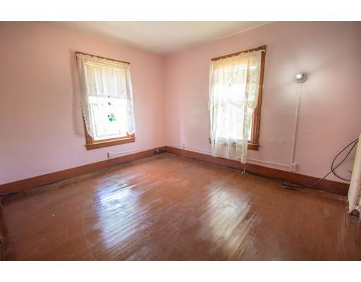 80 Grand Street Springfield, MA 01108 - Photo 17 of 24 an empty room with wooden floor and windows