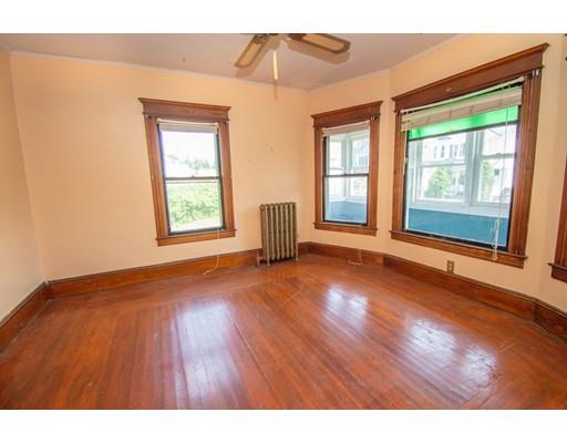 80 Grand Street Springfield, MA 01108 - Photo 3 of 24 a view of an empty room with wooden floor and a window