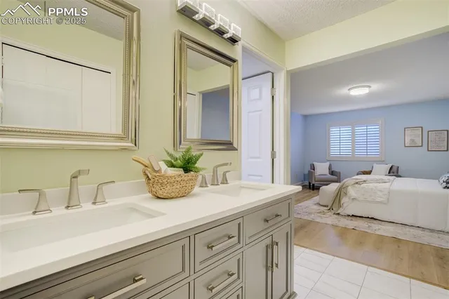 a bathroom with a granite countertop sink and a mirror
