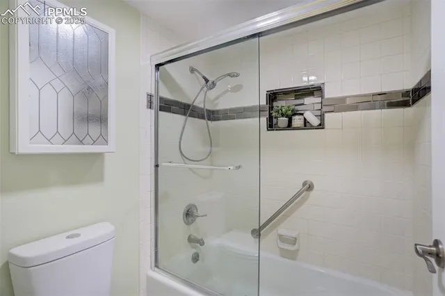 a bathroom with a shower a toilet and sink