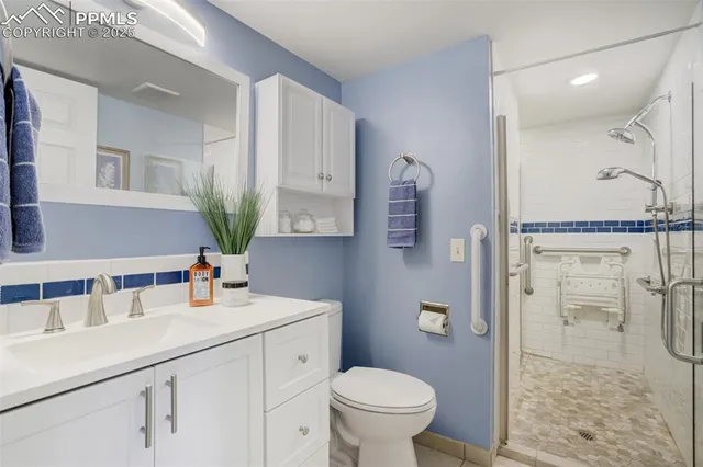 a bathroom with a sink toilet and shower
