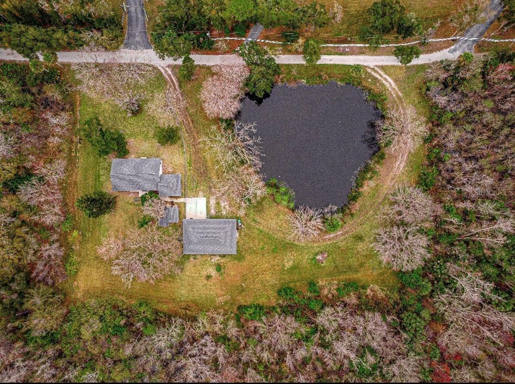 an aerial view of residential house with outdoor space and swimming pool
