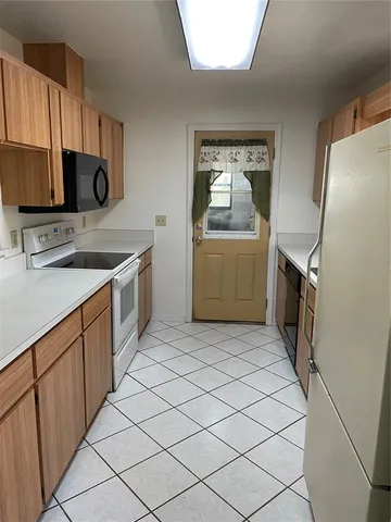 a kitchen with a sink stove and refrigerator