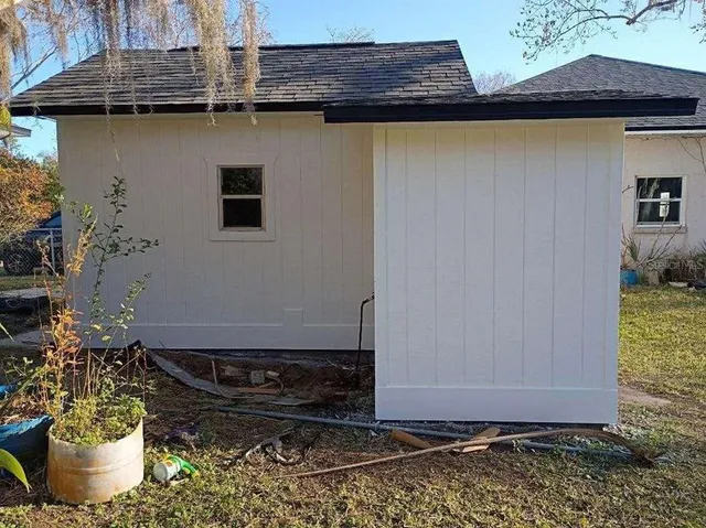 a backyard of a house with barbeque oven