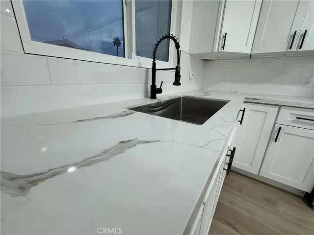 a kitchen with a sink and cabinets