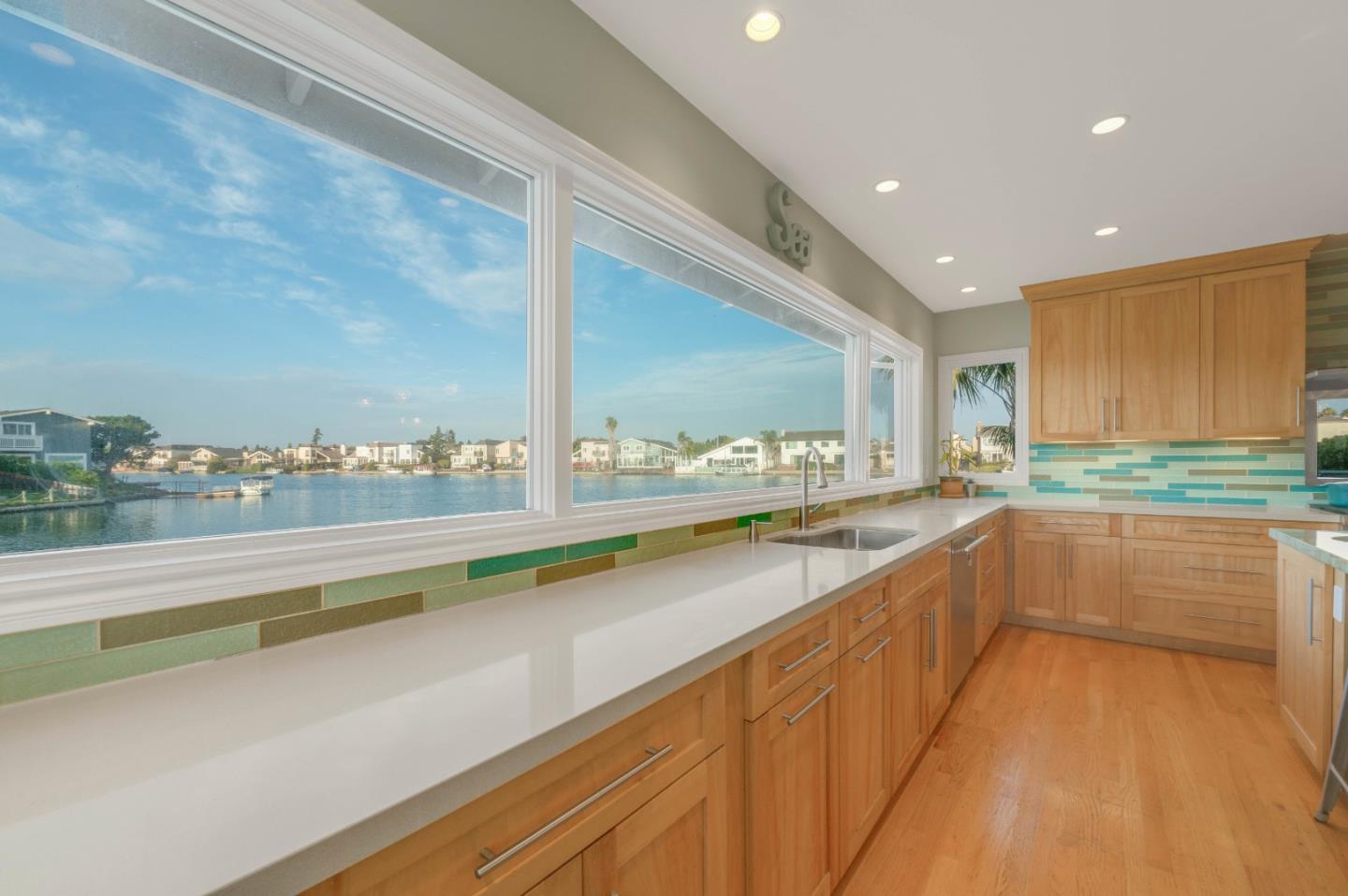 a large white kitchen with a large window