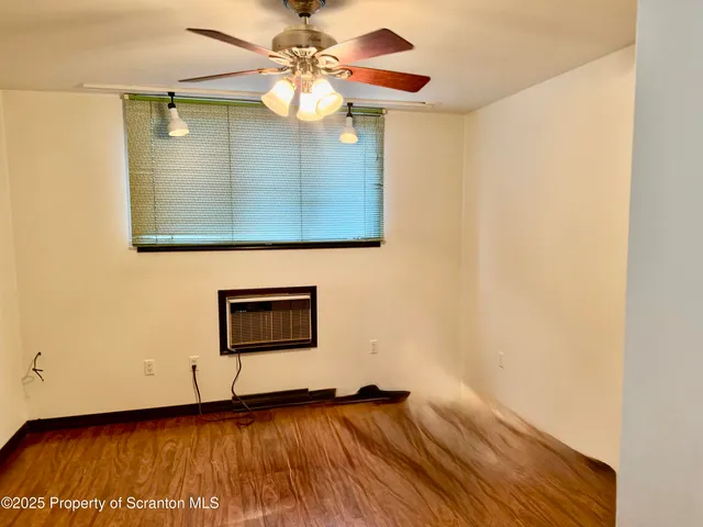 a view of an empty room with a gallery and wooden floor