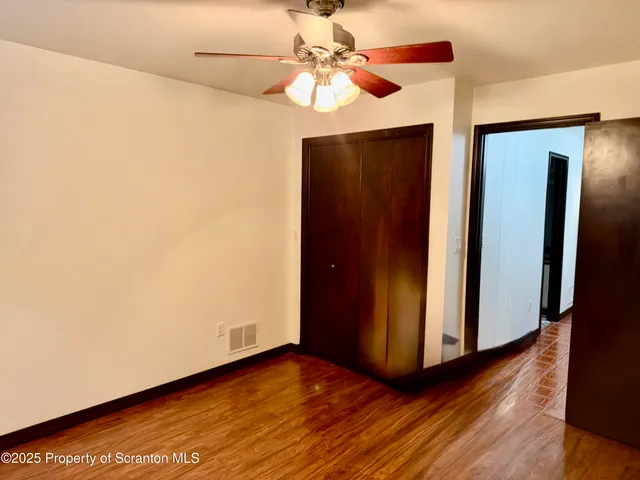 a view of an empty room and closet area