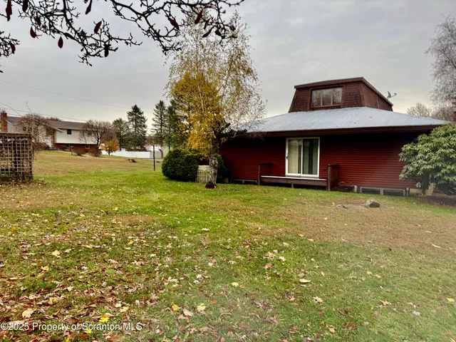 a backyard of a house with lots of green space