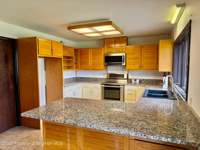 a kitchen with a refrigerator and a sink
