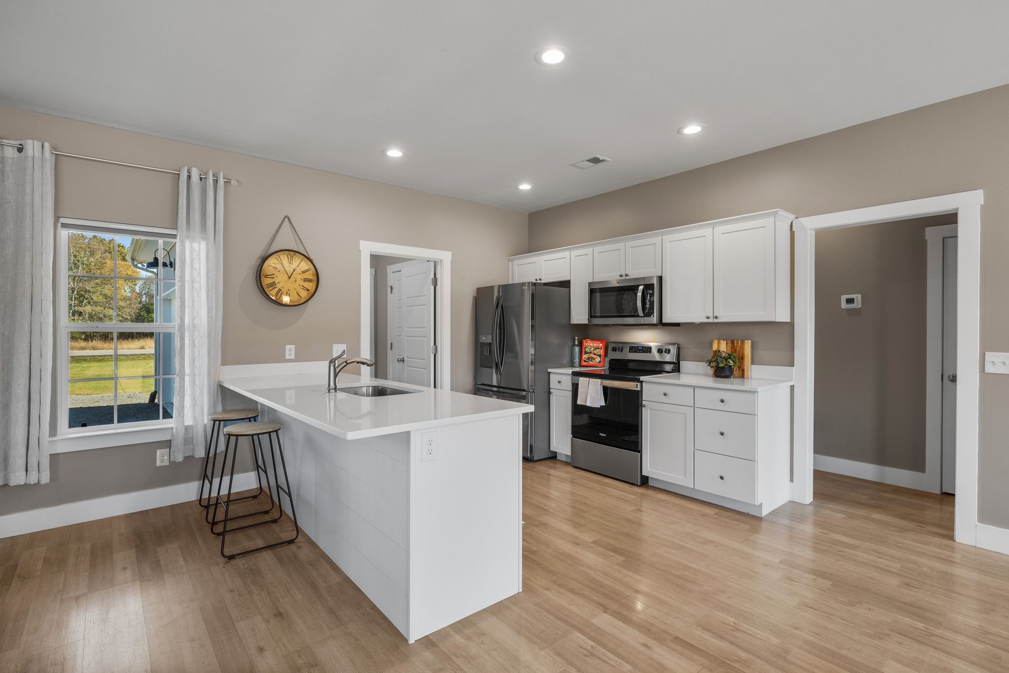 3200 Rucker Road Christiana, TN 37037 - Photo 6 of 31 a kitchen with stainless steel appliances granite countertop a stove top oven a sink dishwasher and a refrigerator with wooden floor