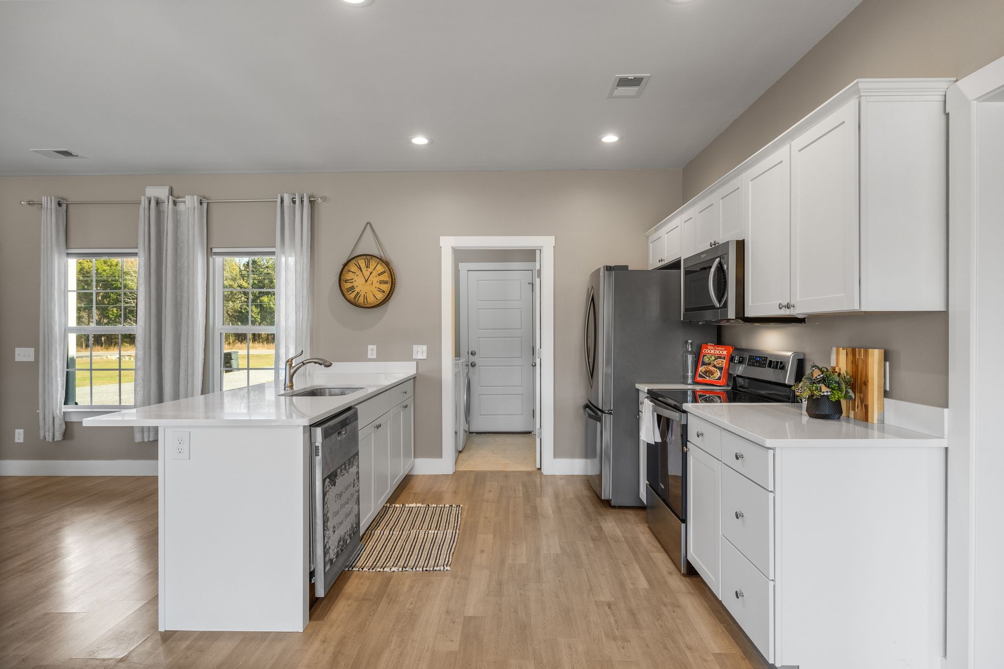 3200 Rucker Road Christiana, TN 37037 - Photo 7 of 31 a kitchen with stainless steel appliances granite countertop a stove a sink a refrigerator and white cabinets with wooden floor
