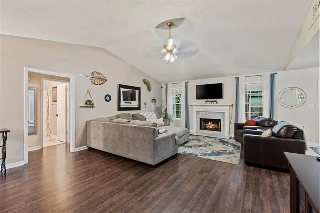 a living room with furniture a fireplace and a flat screen tv