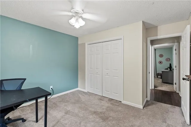 a view of a workspace with furniture and a chandelier fan