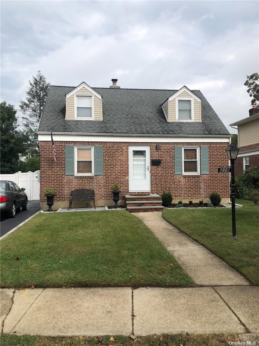 428 Emory Road Mineola, NY 11501 - Photo 1 of 1 a front view of a house with a garden