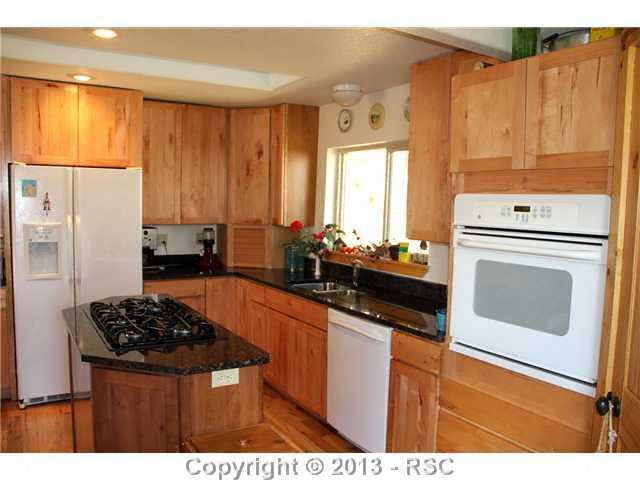 1122 NORTH Rd Divide Divide, CO 80814 - Photo 12 of 25 Gorgeous kitchen with granite, alder cabinets & pantry - gas stove on island, recessed lighting and wall oven
