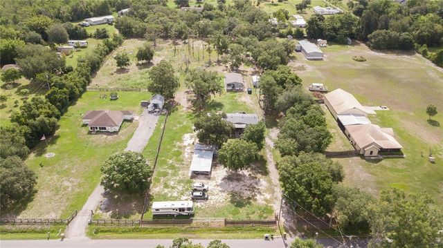an aerial view of residential houses with yard