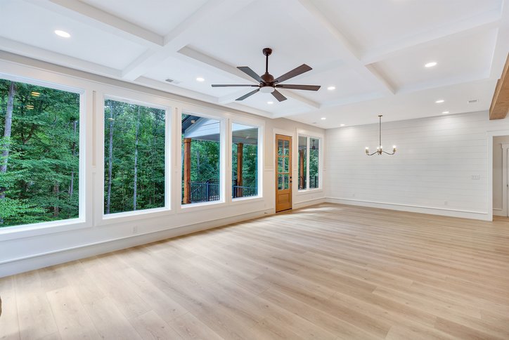 1422 Hunters Trail Anderson, SC 29625 - Photo 15 of 41 A spacious room with abundant natural light, showcasing hardwood floors and a picturesque wooded view.