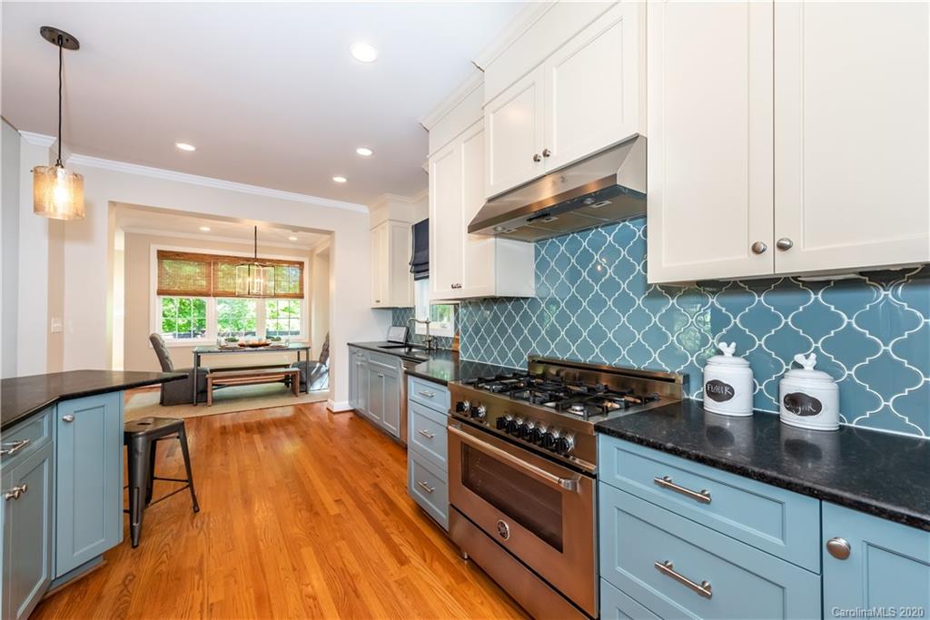 1315 Lilac Road Charlotte, NC 28209 - Photo 12 of 48 a kitchen with stainless steel appliances granite countertop a stove a sink and a refrigerator