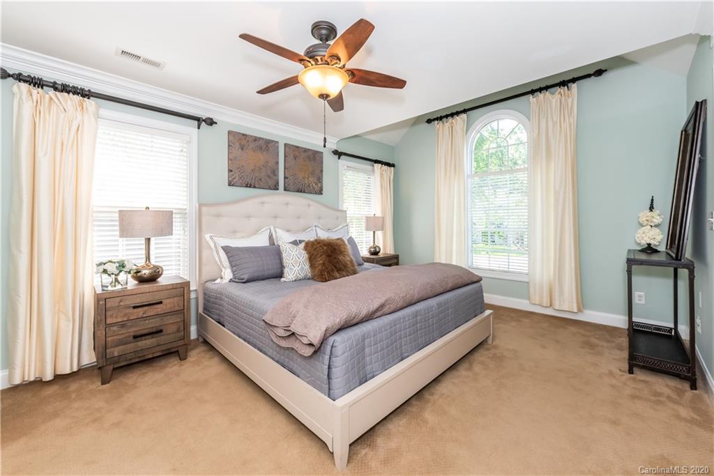 1315 Lilac Road Charlotte, NC 28209 - Photo 19 of 48 a bed room with a bed and a chandelier