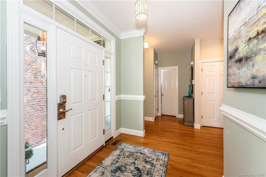 1315 Lilac Road Charlotte, NC 28209 - Photo 3 of 48 a view of a hallway with bathroom and wooden floor