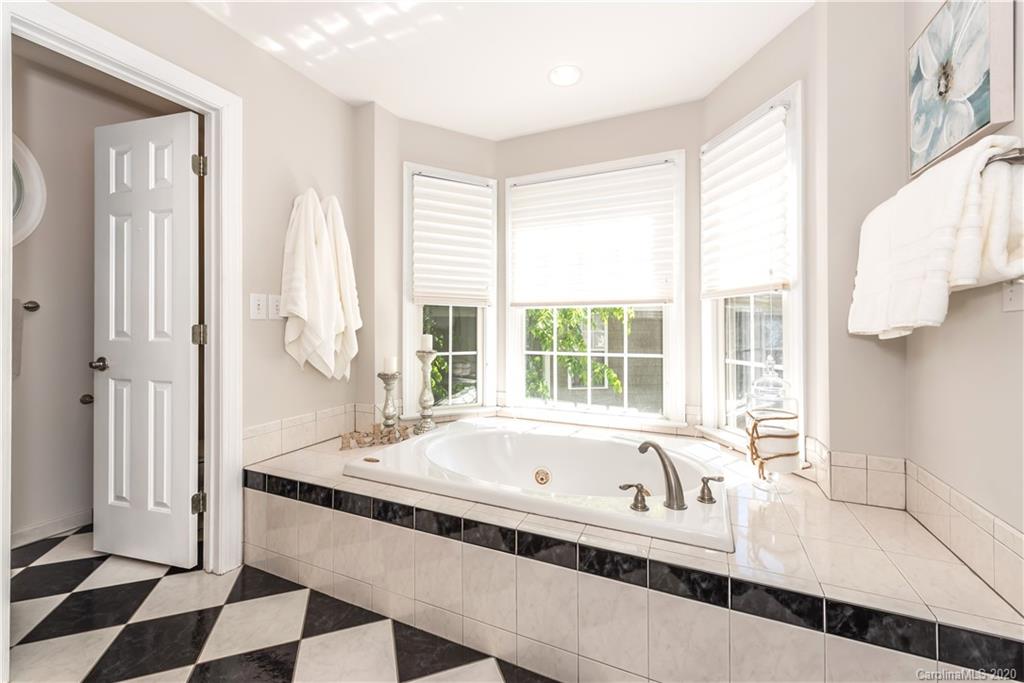 1315 Lilac Road Charlotte, NC 28209 - Photo 22 of 48 a bath tub sitting in a bathroom next to a window