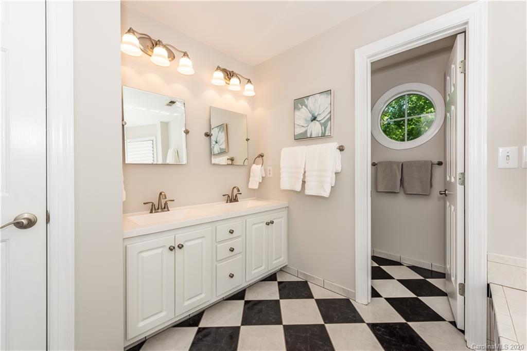 1315 Lilac Road Charlotte, NC 28209 - Photo 23 of 48 a kitchen with a sink a toilet a window and cabinets