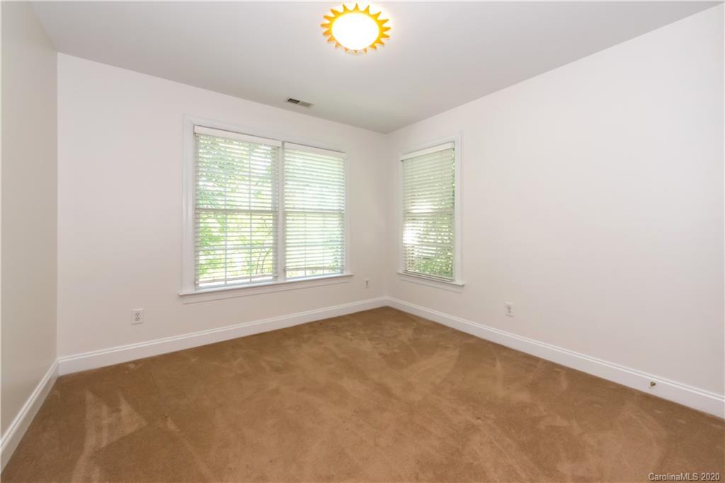 1315 Lilac Road Charlotte, NC 28209 - Photo 24 of 48 a view of an empty room with a window