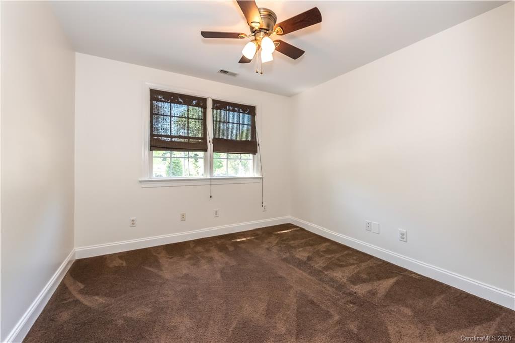 1315 Lilac Road Charlotte, NC 28209 - Photo 26 of 48 an empty room with a window and a fan