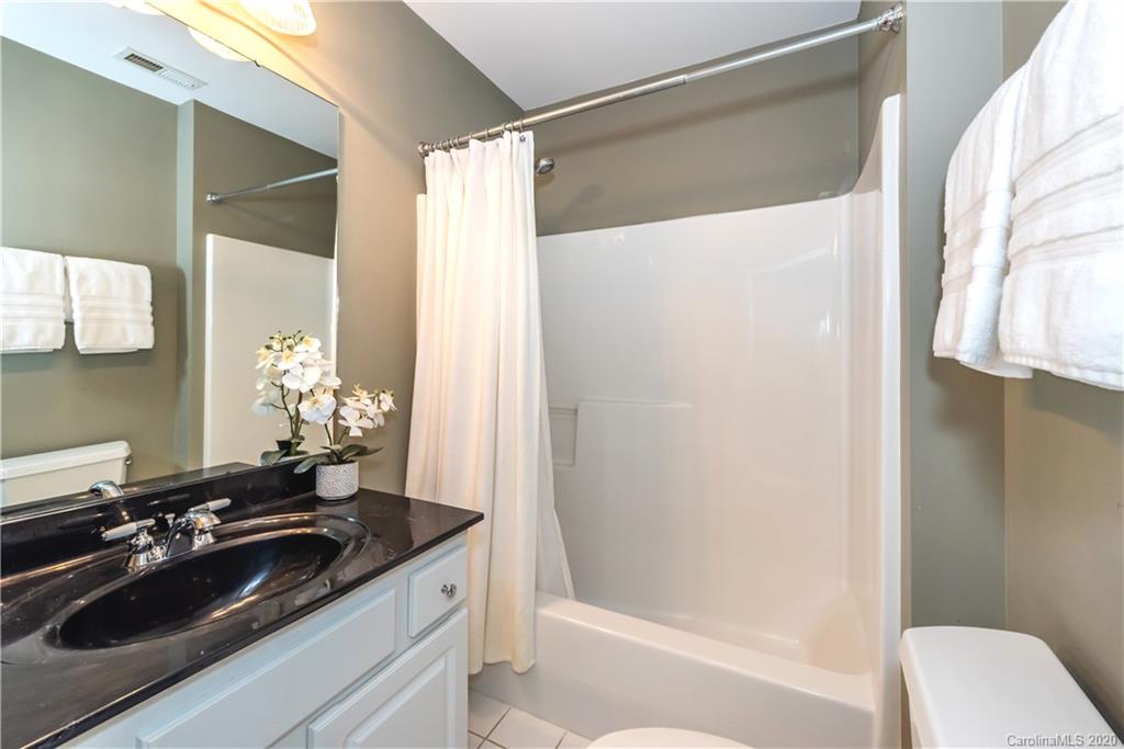 1315 Lilac Road Charlotte, NC 28209 - Photo 27 of 48 a bathroom with a sink and a mirror