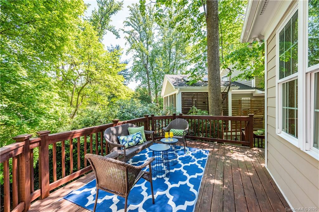 1315 Lilac Road Charlotte, NC 28209 - Photo 28 of 48 a view of a chair and table on the wooden deck