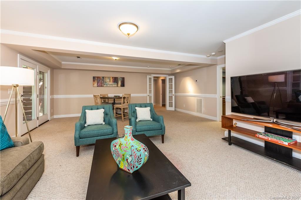 1315 Lilac Road Charlotte, NC 28209 - Photo 31 of 48 a living room with furniture and a flat screen tv