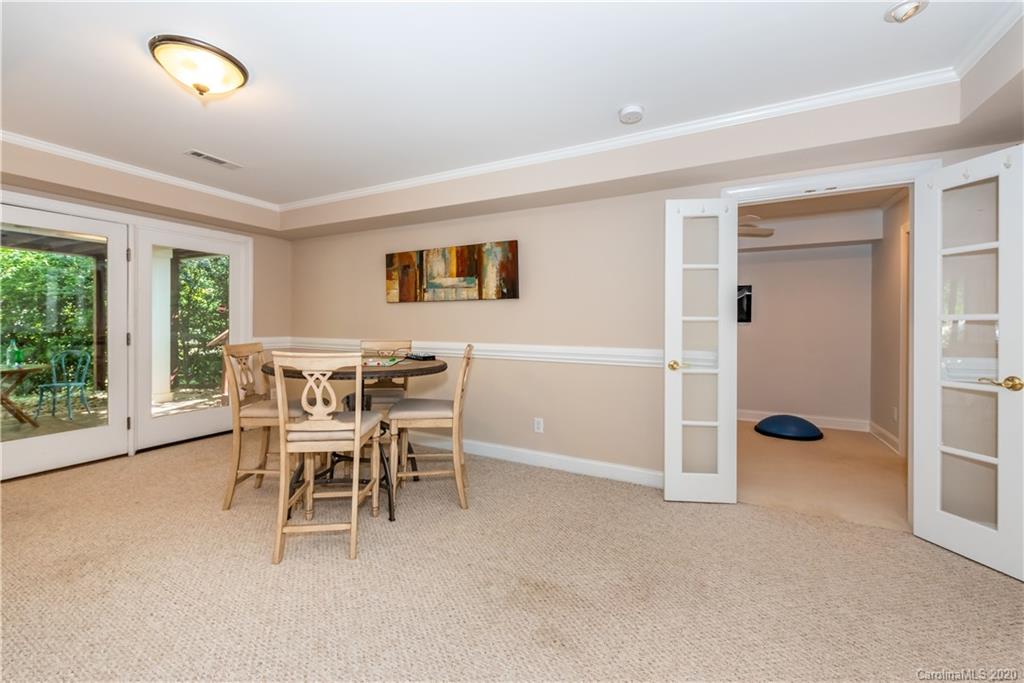 1315 Lilac Road Charlotte, NC 28209 - Photo 32 of 48 a dining room with furniture and a floor to ceiling window