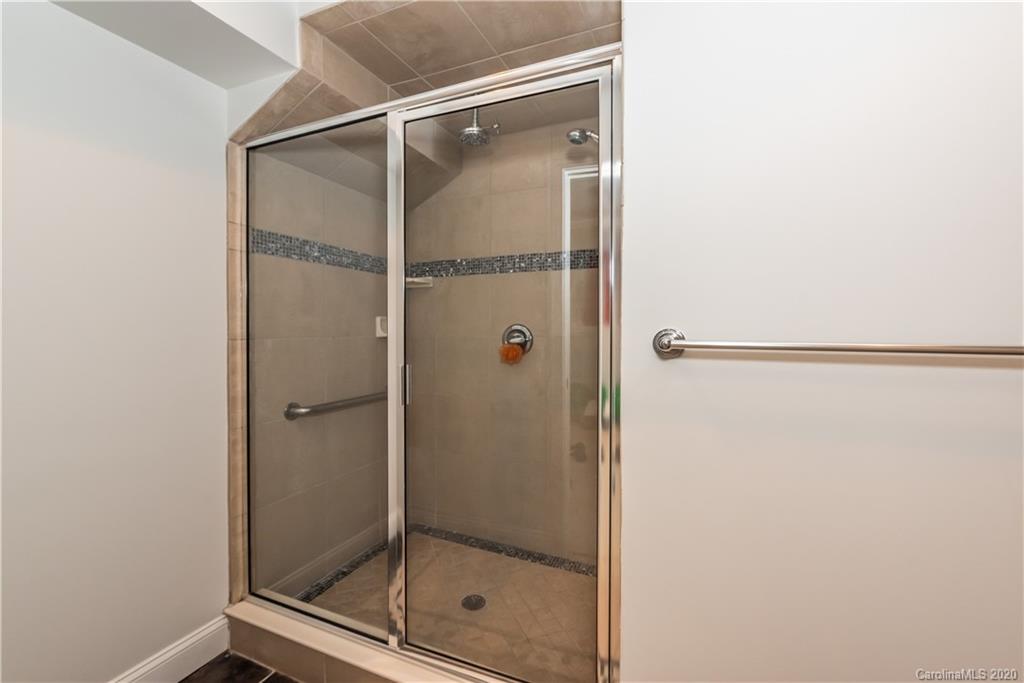 1315 Lilac Road Charlotte, NC 28209 - Photo 36 of 48 a bathroom with a glass shower door