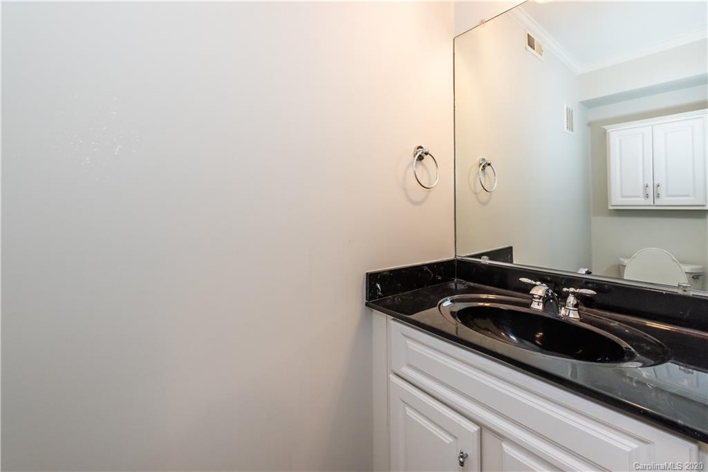 1315 Lilac Road Charlotte, NC 28209 - Photo 37 of 48 a bathroom with a sink and cabinets