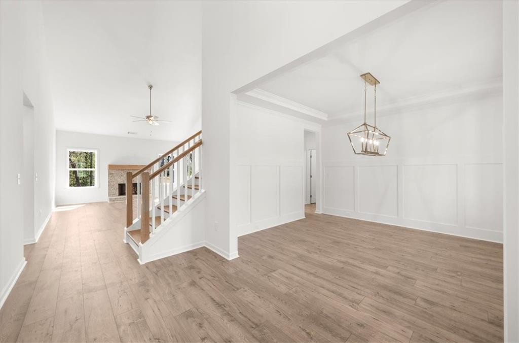 8905 Bethel Road Gainesville, GA 30506 - Photo 13 of 72 a view of an empty room with wooden floor and staircase
