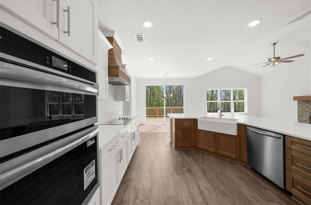 8905 Bethel Road Gainesville, GA 30506 - Photo 24 of 72 a large kitchen with stainless steel appliances wooden floor and a large window